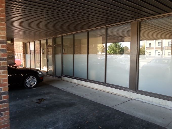 A great job done by CJ Window Tinting. This is a view of the front of  a real estate office in Chatham with frosted film..